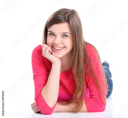 Photo: Portrait of a smiling young woman lying on the floor Portrait of a smiling young woman lying on the floor