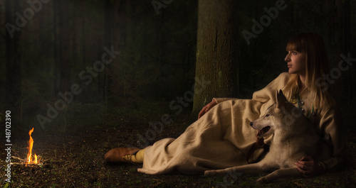 Photo: Slavonian girl and siberian husky in the deep forest Slavonian girl and siberian husky in the deep forest