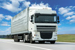 White lorry with grey trailer over blue sky