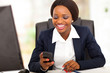 happy african american busniesswoman reading sms in office