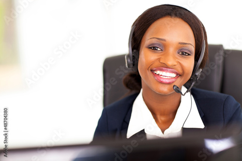 Photo: happy african american telephonist in front of computer happy african american telephonist in front of computer