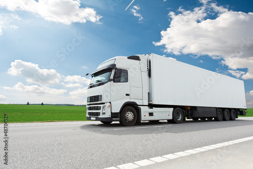 Photo: white lorry with trailer over blue sky white lorry with trailer over blue sky