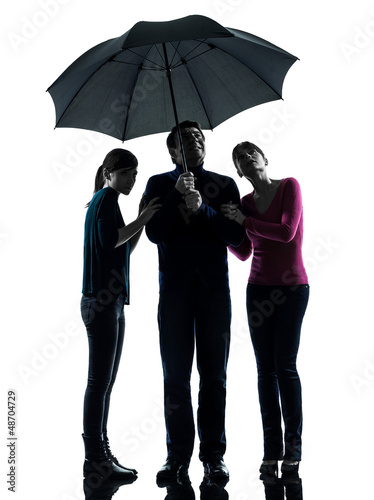 Photo: family father mother daughter under umbrella danger afraid si family father mother daughter under umbrella danger afraid si