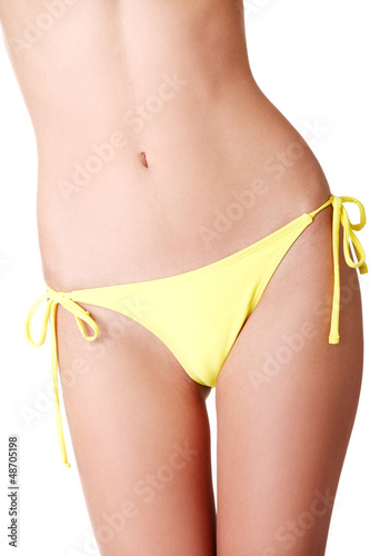 Photo: Sexy belly of fit young woman in bikini. Sexy belly of fit young woman in bikini.
