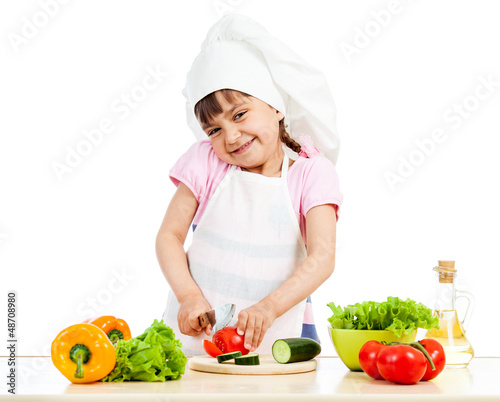 Photo: Chef girl preparing healthy food over white background Chef girl preparing healthy food over white background