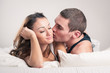 Happy young couple close up portrait in a romantic mood in bedro