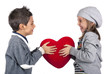 Couple of kids playing with red heart over white background. 