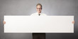Photo: Smiling businessman showing white empty panel. Smiling businessman showing white empty panel.