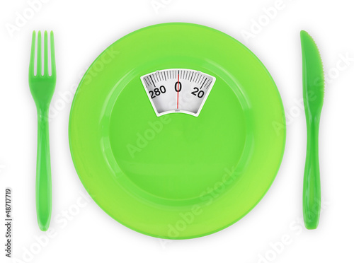Photo: Diet recipe. Green plate with weight scale Diet recipe. Green plate with weight scale