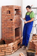 Worker building masonry heater