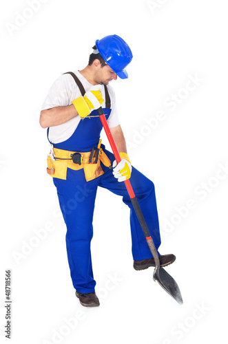 Photo: Worker in uniform working with a shovel Worker in uniform working with a shovel