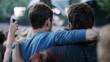 Two guy friends in a crowd bouncing together to the music at an 