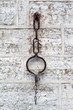 Old rusty medieval shackles on a public street