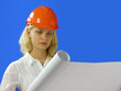 woman architect wearing a hardhat examining blueprints