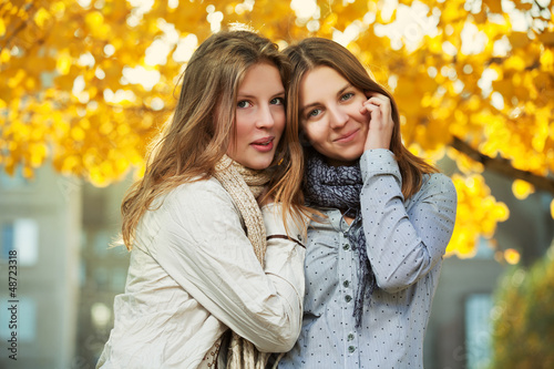 Photo: Young girls in an autumn park Young girls in an autumn park