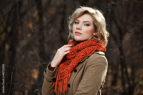 Photo: Young woman walking in autumn forest Young woman walking in autumn forest