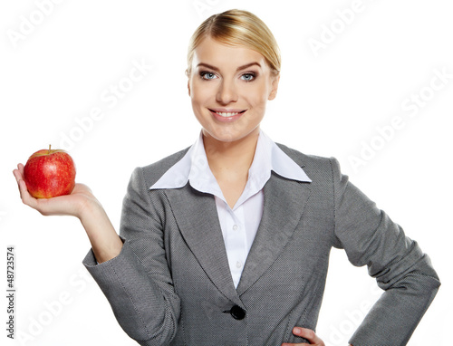 Photo: Businesswoman with red apple in her hand - healthy eating concep Businesswoman with red apple in her hand - healthy eating concep