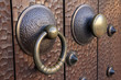 Photo: Medieval metal handle and doorknob on a wooden door Medieval metal handle and doorknob on a wooden door