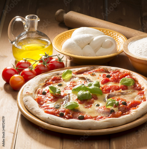 Photo: pizza with ingredients on wooden table pizza with ingredients on wooden table
