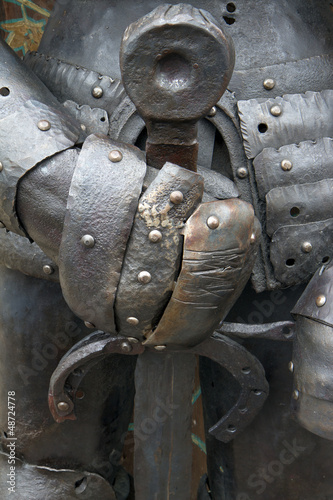Photo: Medieval iron knight holding metal sword Medieval iron knight holding metal sword