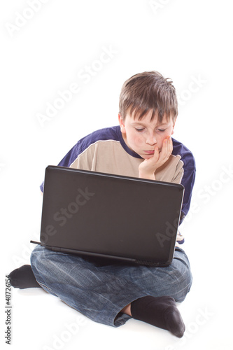 Photo: teenage boy with a laptop teenage boy with a laptop