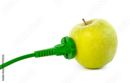 Photo: Green power cable attached to apple outlet Green power cable attached to apple outlet