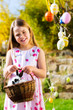 Child on Easter egg hunt with bunny