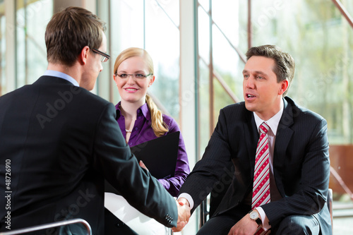 Photo: Man having an interview with manager and partner employment job Man having an interview with manager and partner employment job