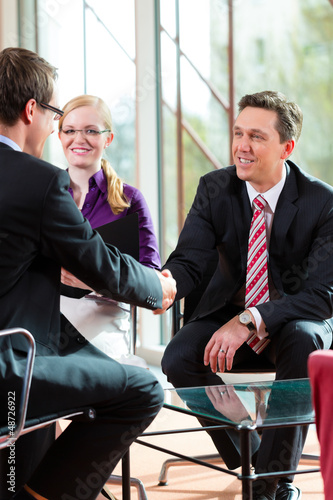 Photo: Man having an interview with manager and partner employment job Man having an interview with manager and partner employment job