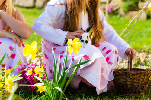 Photo: Children on Easter egg hunt with bunny Children on Easter egg hunt with bunny