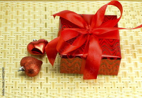 Photo: Gift and hearts on a wicker wood Gift and hearts on a wicker wood