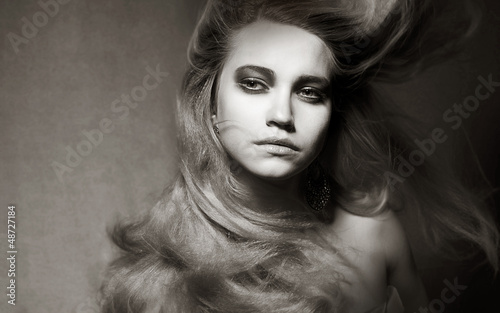 Photo: Attractive Romantic Girl with Windy Hair in Shadows Attractive Romantic Girl with Windy Hair in Shadows