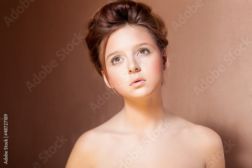 Photo: Portrait of Young Teen Girl over Beige Background Portrait of Young Teen Girl over Beige Background