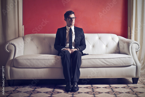 Photo: businessman sitting on sofa businessman sitting on sofa