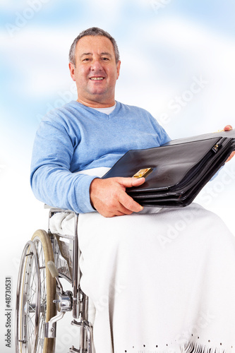 Photo: Man in wheelchair with a briefcase Man in wheelchair with a briefcase