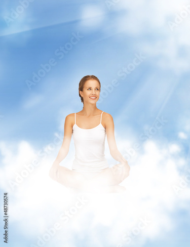 Photo: woman practicing yoga lotus pose woman practicing yoga lotus pose