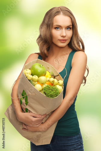 Photo: woman with shopping bag full of fruits woman with shopping bag full of fruits
