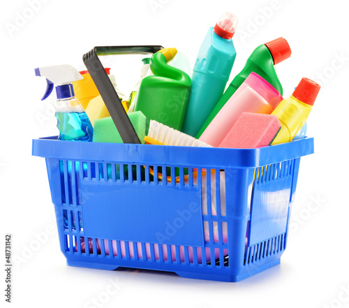 Photo: Shopping basket with detergent bottles isolated on white Shopping basket with detergent bottles isolated on white