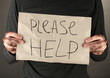 homeless man asks for help, on black background close-up