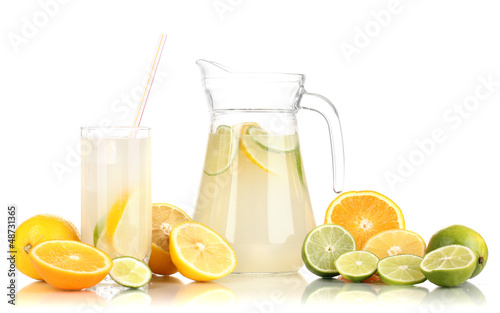 Photo: Citrus lemonade in pitcher and glass of citrus around isolated Citrus lemonade in pitcher and glass of citrus around isolated