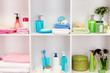 Bath accessories on shelfs in bathroom