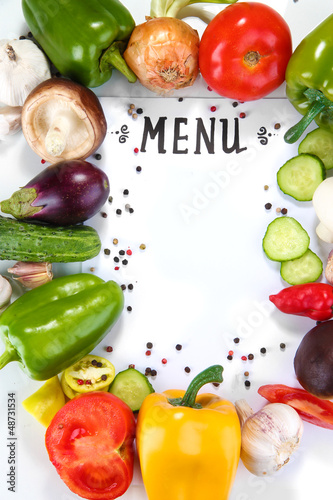 Photo: Menu surrounded by products and vegetables isolated on white Menu surrounded by products and vegetables isolated on white
