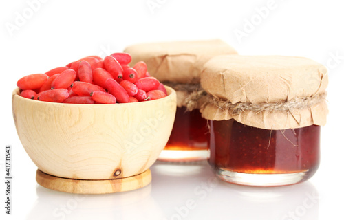 Photo: ripe barberries in wooden bowl and jars of jam isolated white ripe barberries in wooden bowl and jars of jam isolated white
