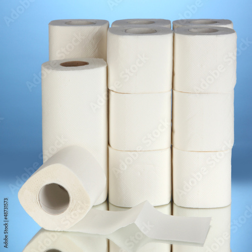 Photo: Rolls of toilet paper on blue background Rolls of toilet paper on blue background
