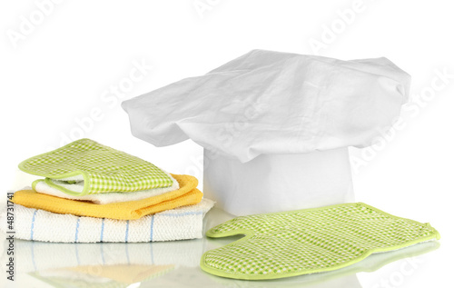 Photo: Chef's hat with kitchen towels and potholders isolated on white Chef's hat with kitchen towels and potholders isolated on white