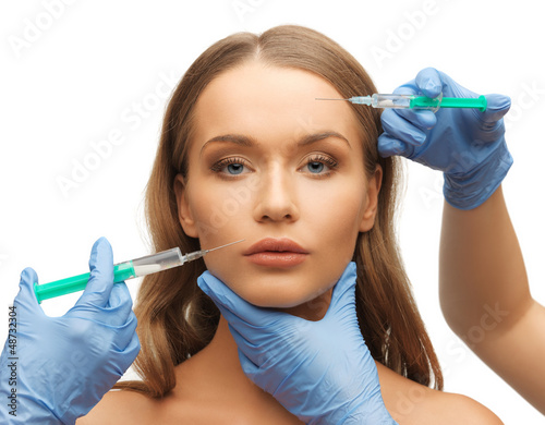 Photo: woman face and beautician hands woman face and beautician hands
