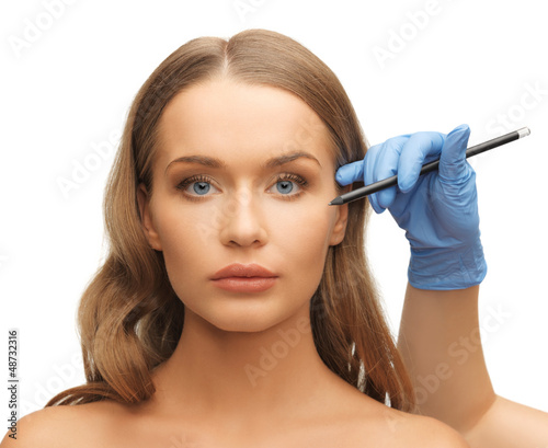 Photo: woman face and beautician hands woman face and beautician hands