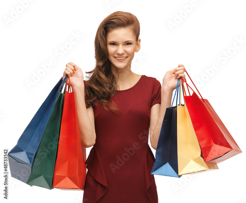 Photo: teenage girl in red dress with shopping bags teenage girl in red dress with shopping bags