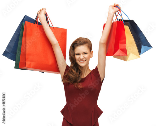 Photo: teenage girl in red dress with shopping bags teenage girl in red dress with shopping bags