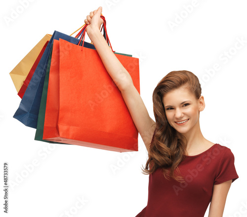 Photo: teenage girl in red dress with shopping bags teenage girl in red dress with shopping bags